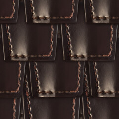 Seamless 4k photo texture material of scaly dark brown leather armor stitched surface.