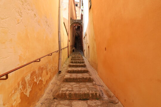 Fototapeta Ruelle bordée de maisons typiques en ocre, village typique de Roussillon, département du Vaucluse, France