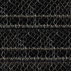 Seamless 4k photo texture material of black colored snake skin leather with stitches.