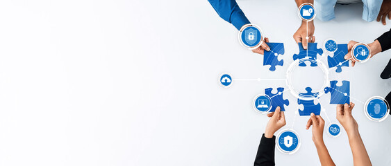 Hands coming together to solve puzzles symbolize teamwork in developing innovative security...