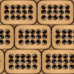 Seamless 4k photo texture material of golden colored leather tile surface with stitching.