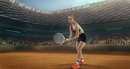 Woman tennis player playing tennis in professional tennis stadium.