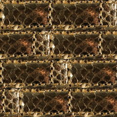 Seamless 4k photo texture material of quilted and golden colored leather tile surface with seams.