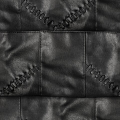 Seamless 4k photo texture material of black leather stitched surface with braiding elements.