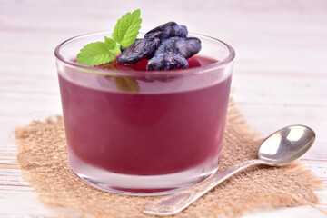 Berry jelly. Honeysuckle berry jelly in a glass. Close-up.
