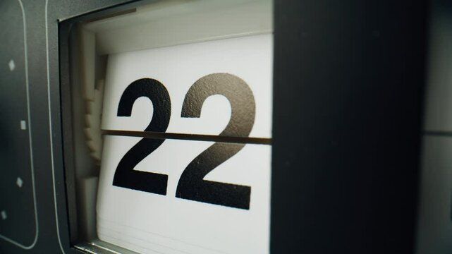 Clock calendar changing panels indoors. Electromechanical watch showing date