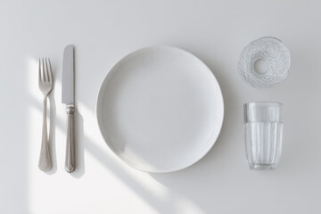 collection of modern designer tableware items on clean white background featuring elegant plates stylish cutlery