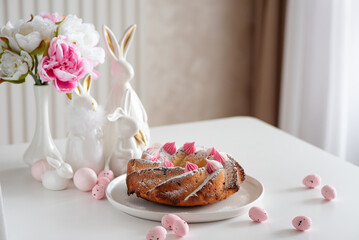 Traditional Easter cakes with icing decorated candies on white wooden table