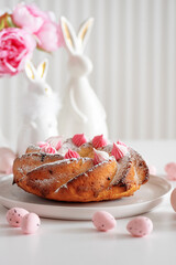 Traditional Easter cakes with icing decorated candies on white wooden table