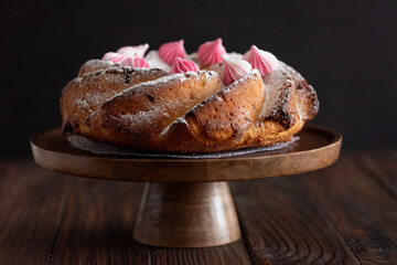 Traditional Easter cakes with icing decorated candies on dark wooden table