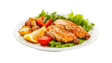 Fototapeta premium Deliciously roasted chicken wings served with potatoes tomatoes lemon and lettuce