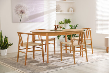 Stylish room with wooden table, chairs and houseplants. Interior design