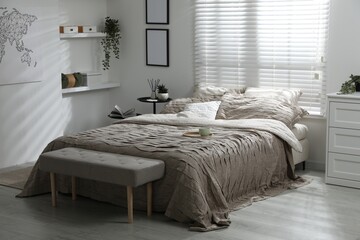 Comfortable bed with beautiful linens in bedroom