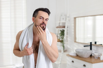 Portrait of handsome man before shaving in bathroom