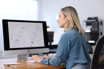 Engineer working with computer at table in office