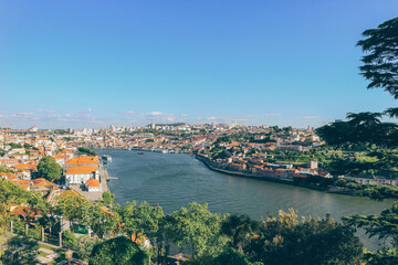view of porto city with wide river duoro crossing on blue clear sky day