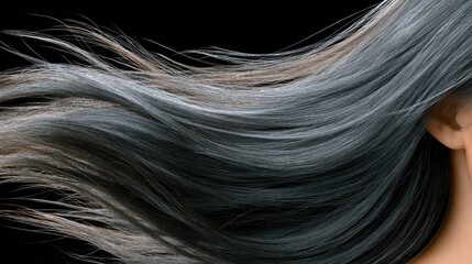 Fototapeta premium Luxurious black hair shines in natural light, showcasing its glossy texture and intricate details against a dark backdrop