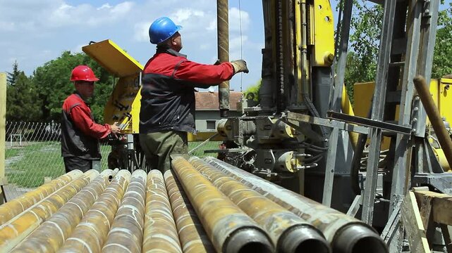 Drilling Rig Workers Drilling Geothermal Well for a Heat Pump. Worker Operates the Drilling Rig Machine. EU Countries Invest in Geothermal Energy. Renewable Energy Source. 