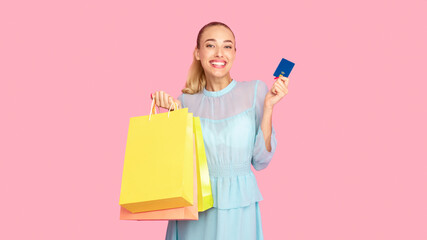 Easy Payment Concept. Portrait of smiling excited woman wearing dress, holding credit card and...