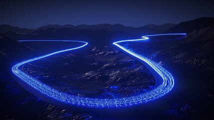 Winding roads illuminated by blue light at night, winding through mountainous terrain