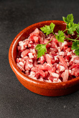 Bacon cubes smoked chopped meat small pieces fresh delicious gourmet food background on table rustic food top view copy space