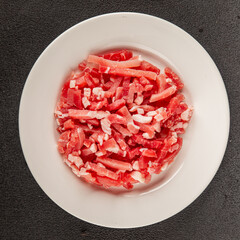 Bacon cubes smoked chopped meat small pieces fresh delicious gourmet food background on table rustic food top view copy space