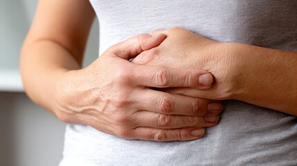 Fototapeta premium Woman Holding Stomach in Pain, Representing Healthcare, Digestion Issues and Medical Conditions