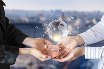 Hands holding a globe with green energy.