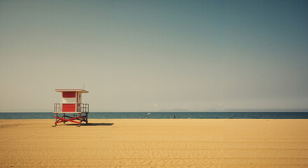 Lifeguard tower on sandy beach with ocean view in sunny weather  