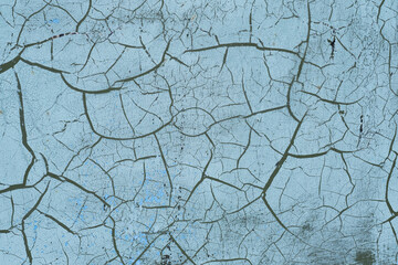 Grunge blue background with cracks and peeling paint. Abstract background.