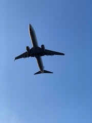 Overhead plane in blue sky