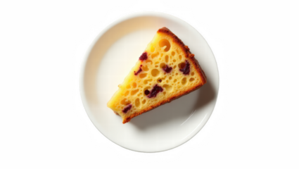 Slice of Jamaican fruit cake on white plate viewed from above  