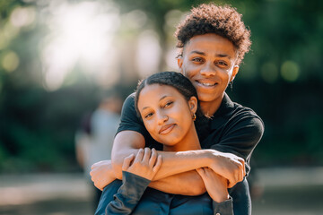 young romantic latin or hispanic couple outdoors embracing