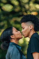 young latin couple kissing outdoors