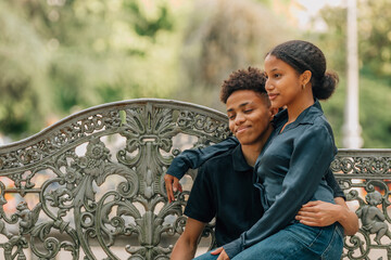 romantic young couple sitting outdoors