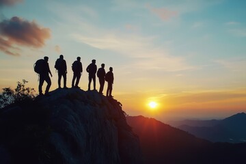 Silhouette of a Triumphant Team on a Mountain Summit at Sunset: A Symbol of Leadership, Courage, and Professional Growth in Life's Challenges