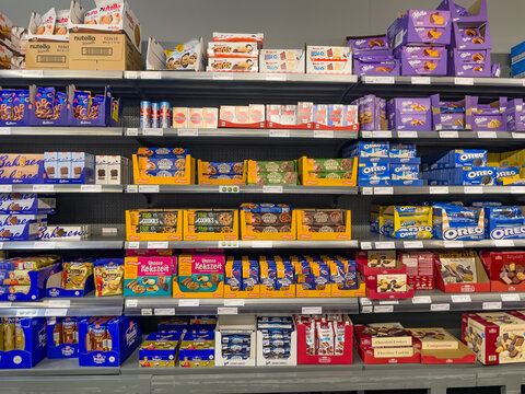 Germany Berlin June 7, 2025. A fully stocked shelf with various cookies, biscuits, and sweet snacks. Popular brands like Oreo, Milka, and Nutella are prominently displayed.