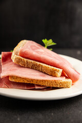 Ham slices meat spam pork fresh delicious gourmet food background on the table rustic food top view copy space