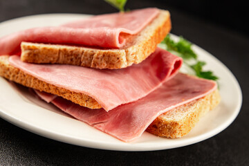 Ham slices meat spam pork fresh delicious gourmet food background on the table rustic food top view copy space