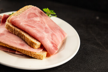 Ham slices meat spam pork fresh delicious gourmet food background on the table rustic food top view...