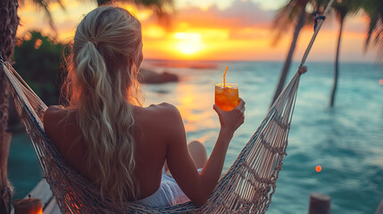 young woman drinking cocktail at the beach