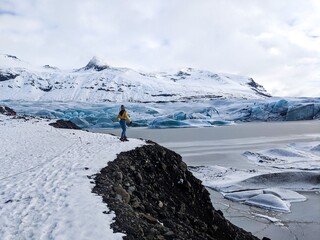 Woman standing in wide open icy winter wonderland, Iceland