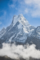 closeup view of fishtail mountain also known as machhapuchare mountain with white cloud and blue sky, nepal
