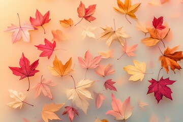A soft, dreamy image of autumn leaves in various shades of red, orange, and yellow, scattered on a muted background.