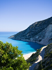 Panoramic view of Myrtos Beach, Kefalonia, captured at sunrise with intense sea colors and white...