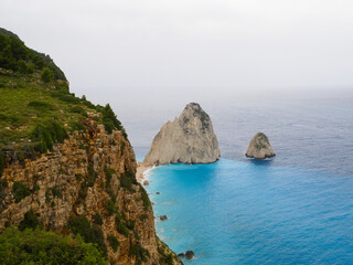 Top view of Mizithres rock formations, Zakynthos island, with turquoise sea and soft cloudy sky.
