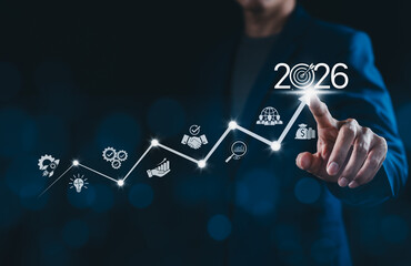 The 2026 new year business goals concept. Businessman touching increase arrow graph company future...