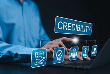 Credibility and trust in business concept. Businessman using laptop with icons credibility, trust, reputation, verification, integrity, reliable, authentic, commitment, regard, and quality assurance.