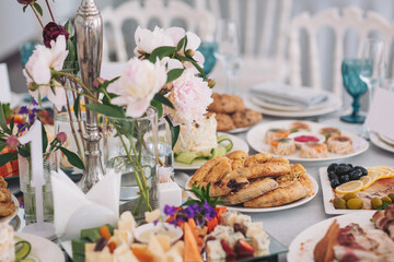 Festive table adorned with an array of delectable dishes and vibrant floral arrangements for a joyful gathering