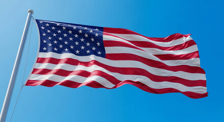 Fototapeta premium A vibrant American flag proudly waves against a clear, brilliant blue sky, symbolizing freedom, patriotism, and national identity. Ideal for national holidays, political campaigns, and celebrating